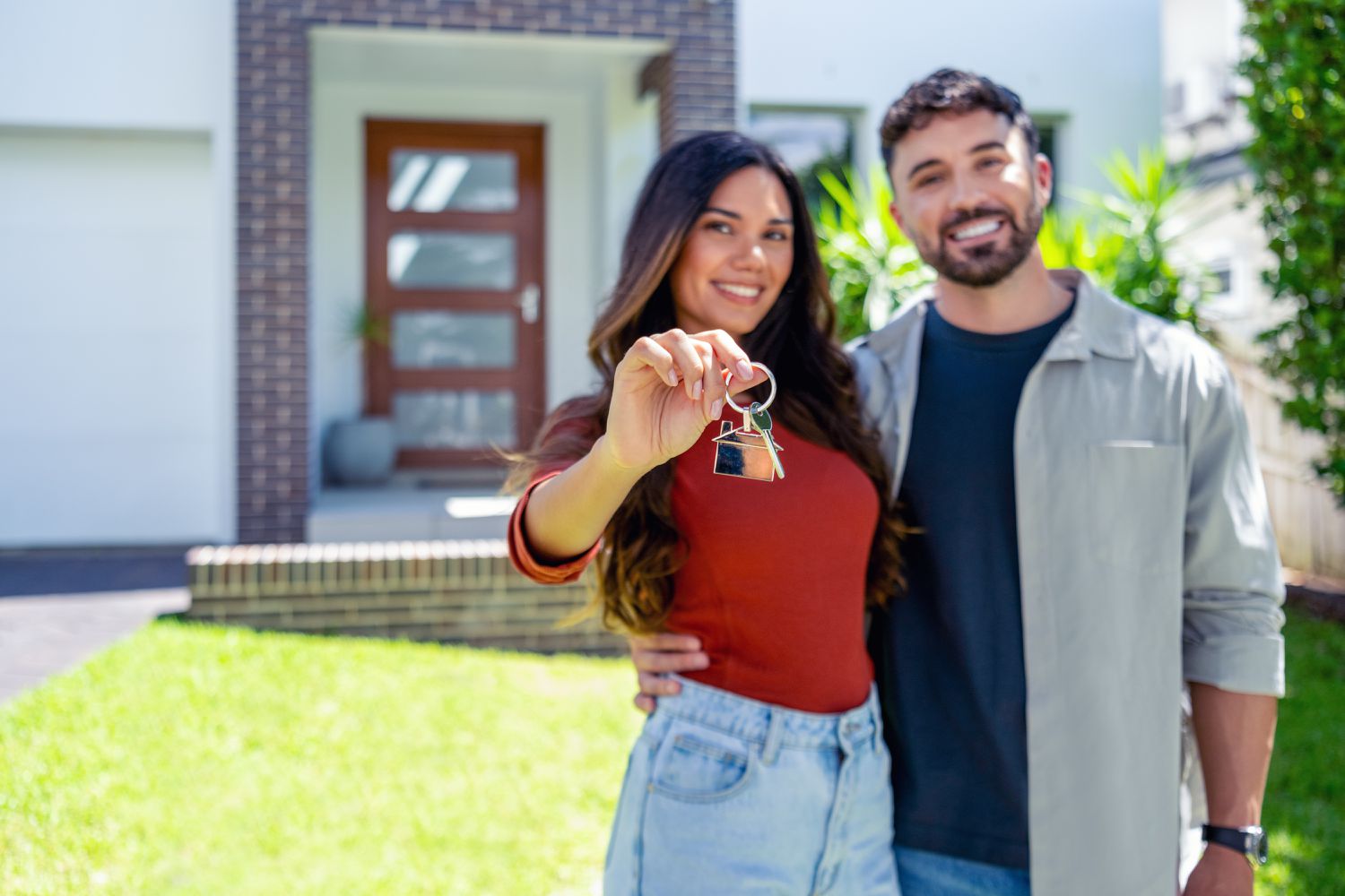 Couple in front of new home