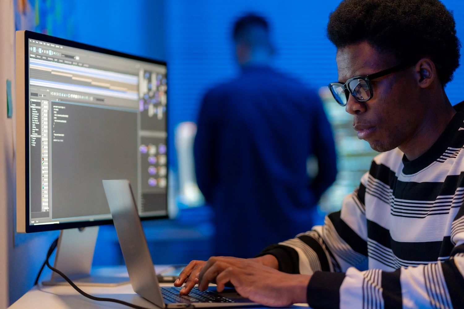 Two software developers with computer screens