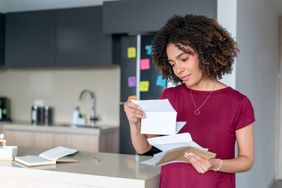 A woman reads mail.