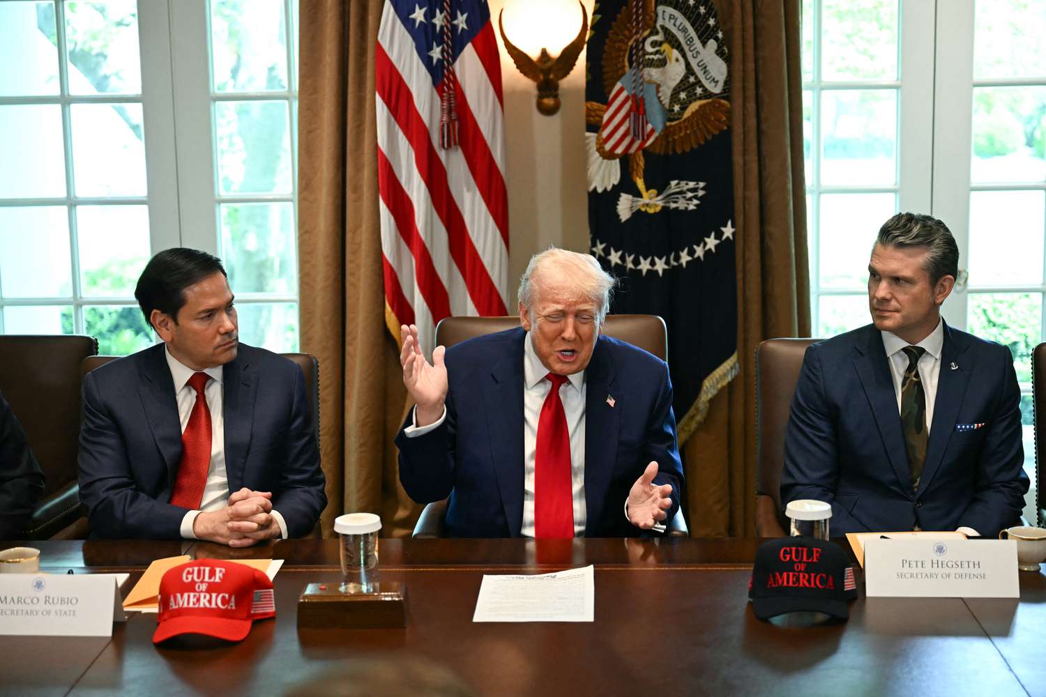 US President Donald Trump, flanked by Secretary of State Marco Rubio (L) and Defense Secretary Pete Hegseth (R), speaks during a cabinet meeting in the Cabinet Room of the White House in Washington, DC, on April 30, 2025. 