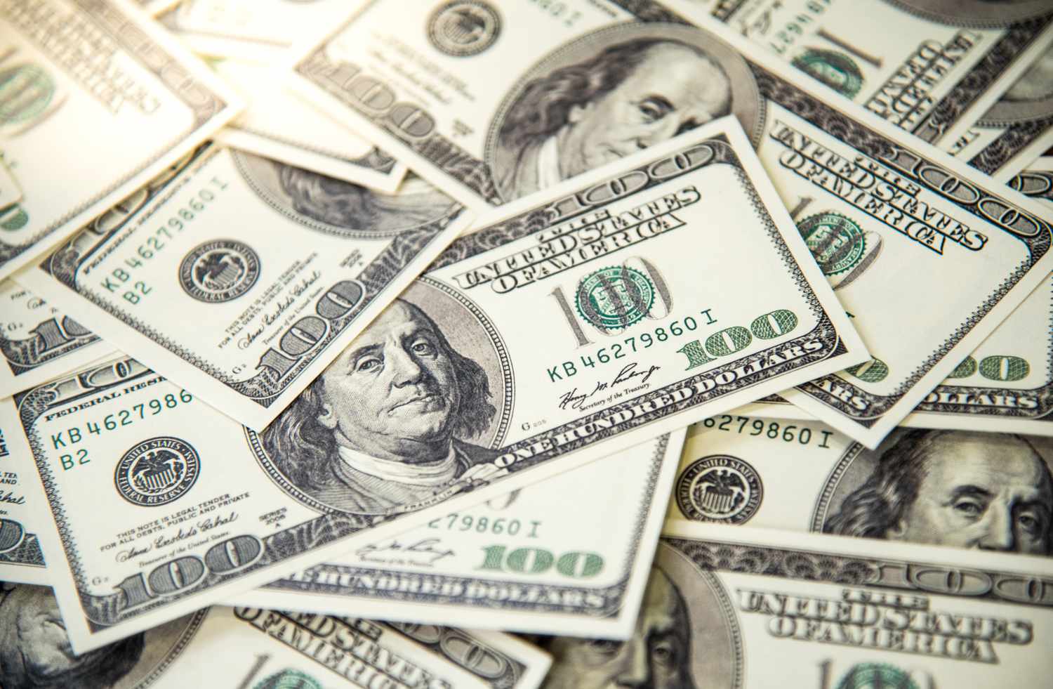 Pile of banknotes of one hundred dollars.