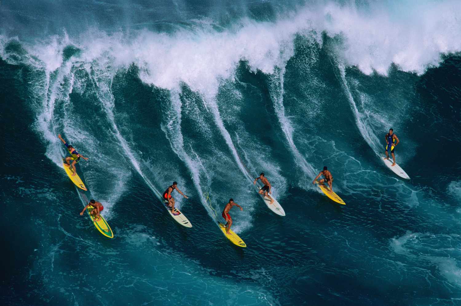 Surfers in Hawaii on a large wave