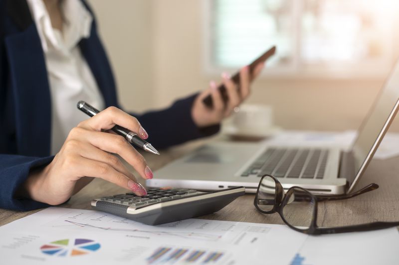 Close up of accountant or banker making calculations.