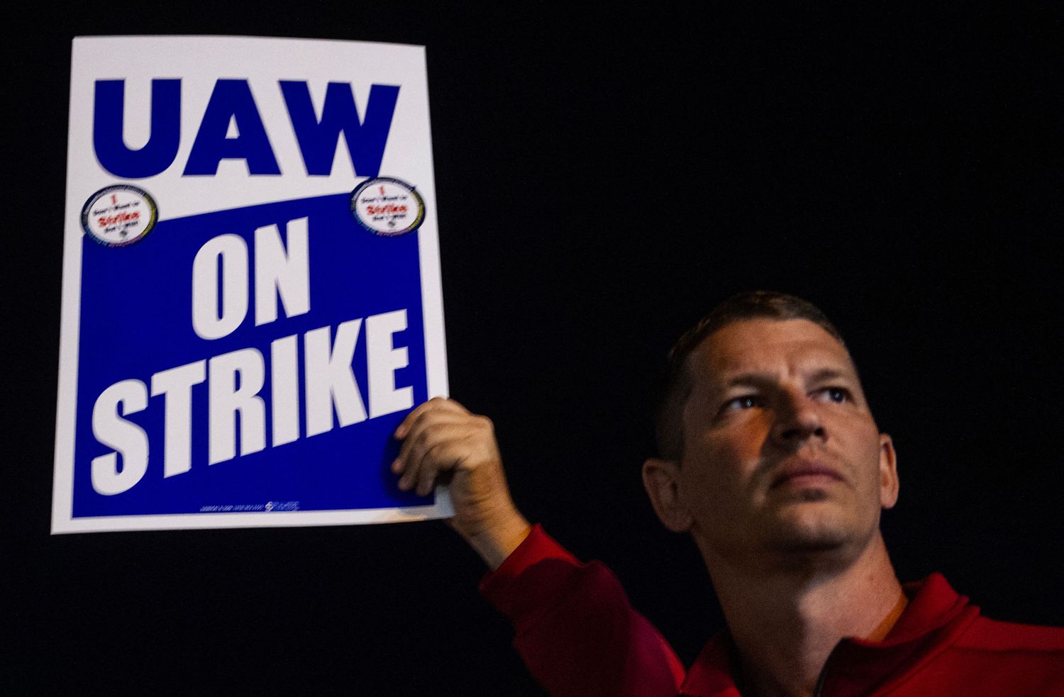 Members of the UAW (United Auto Workers) picket and hold signs outside of the UAW Local 900 headquarters across the street from the Ford Assembly Plant in Wayne, Michigan.