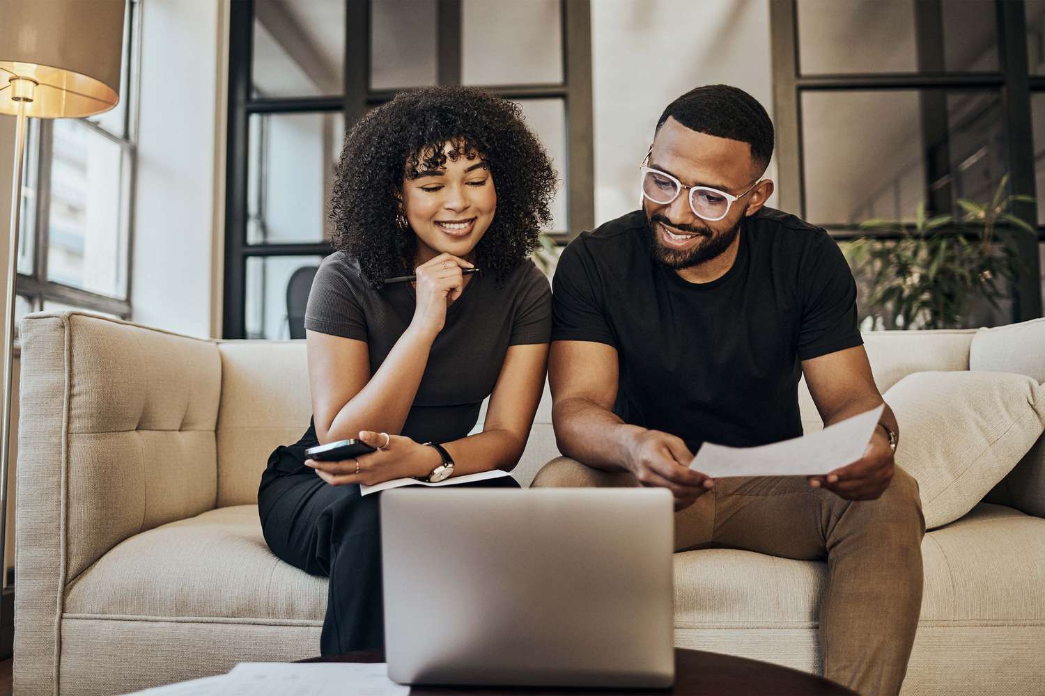 Black couple, looking at life insurance and finance documents for bill payments at home