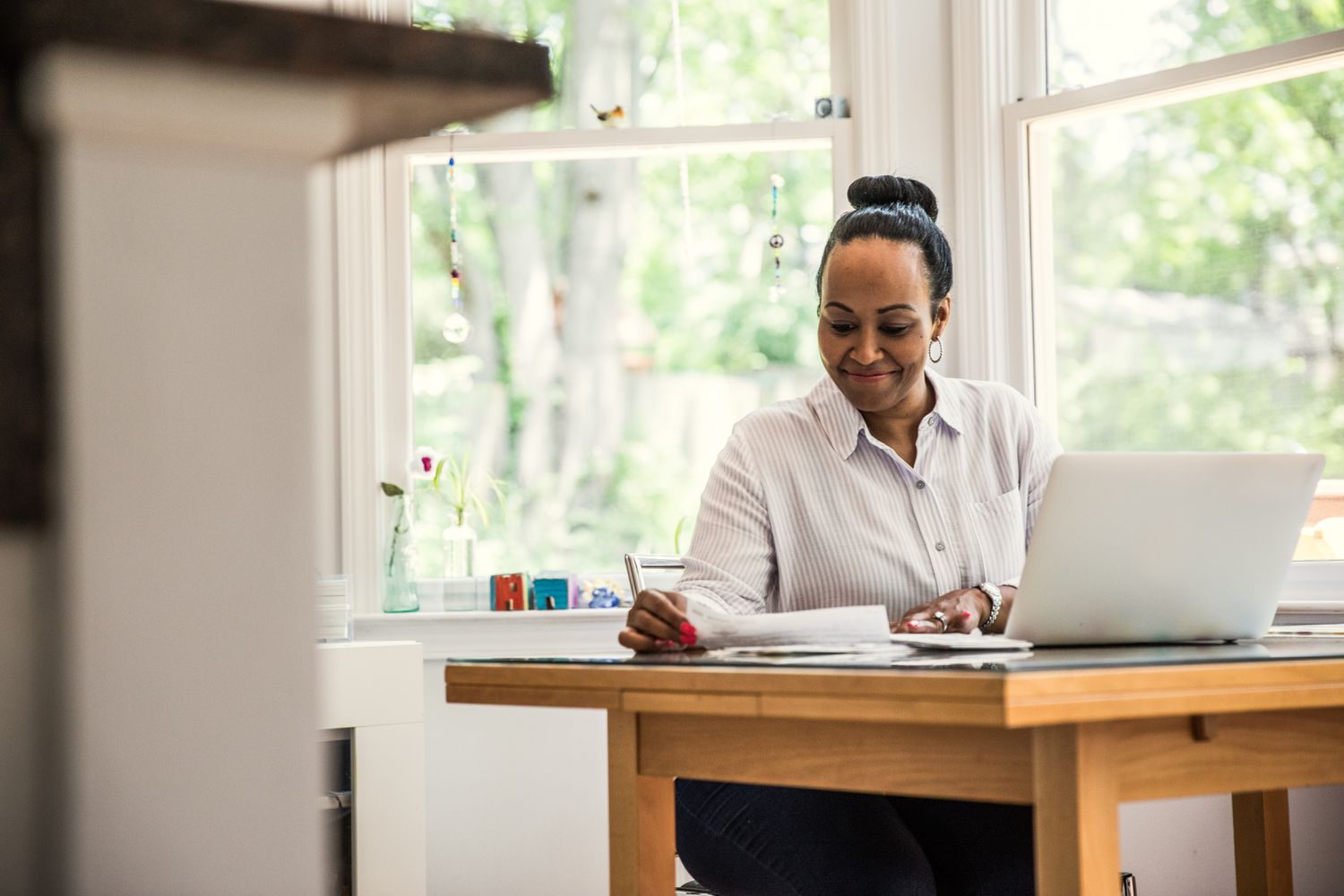 Woman working on laptop in kitchen