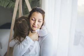 Mother hugging child