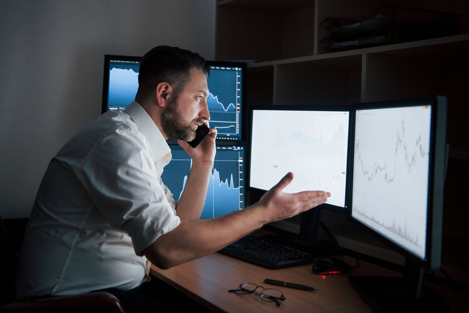 Trader having a conversation on the phone to make verbal agreement on writing an option. 