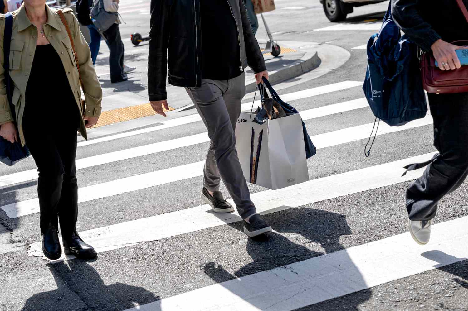 A shopper carries shopping bags in San Francisco, California, US, on Friday, June 7, 2024. 