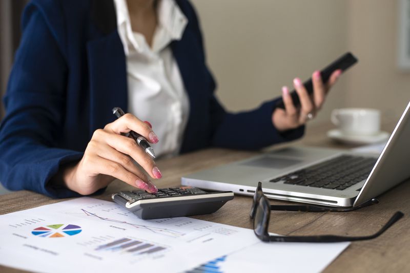 accountant at desk with calculator