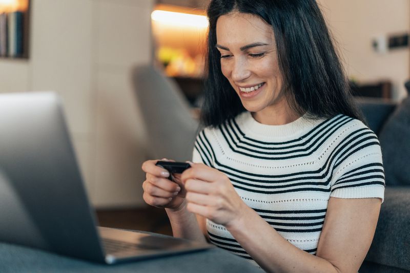 A woman using hard wallet for storing cryptocurrency.
