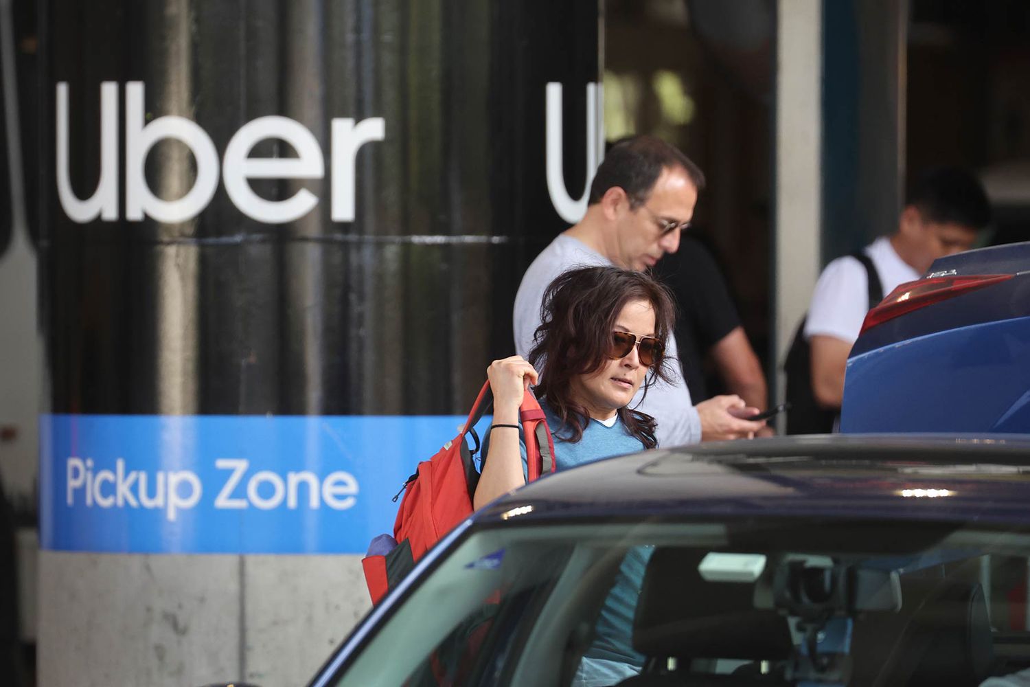Travelers wait for an Uber ride at Midway International Airport in Chicago, Illinois. 