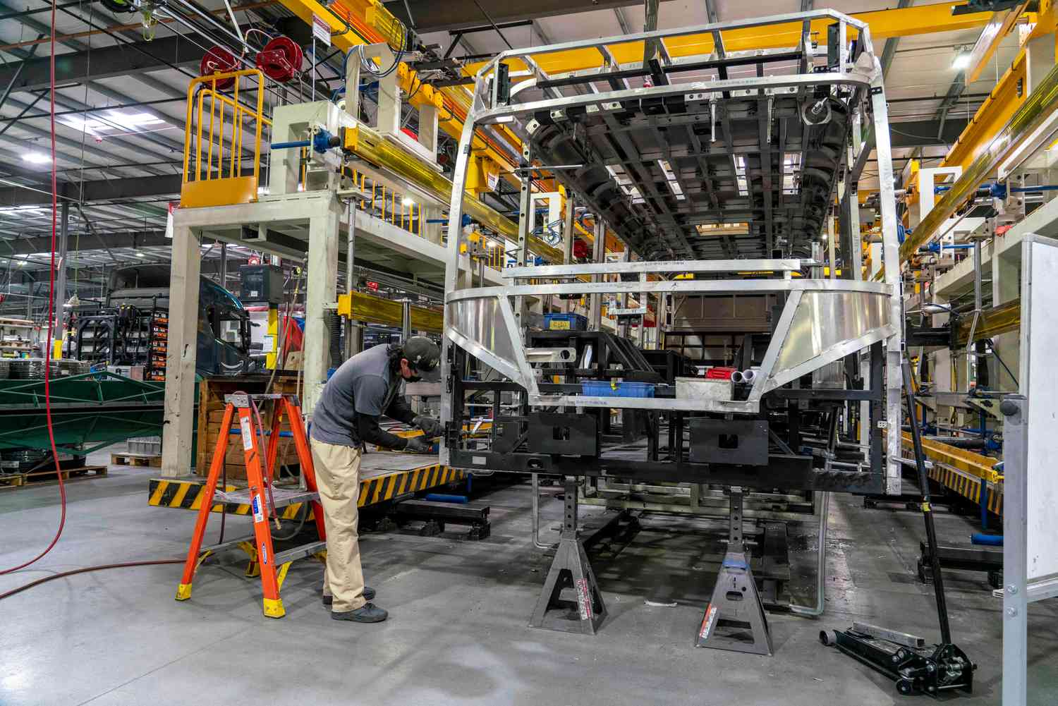 An employee works on the beginning stages of manufacturing a bus at the BYD Coach and Bus factory in Lancaster, California, US, on Thursday, Feb. 2, 2023.