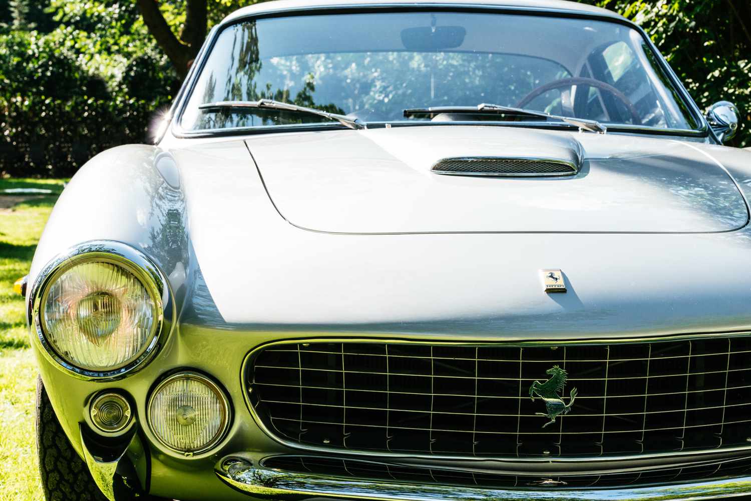 The Ferrari 250 GT parked outdoors in park on sunny summer day near the Potsdam lakes, Germany. 