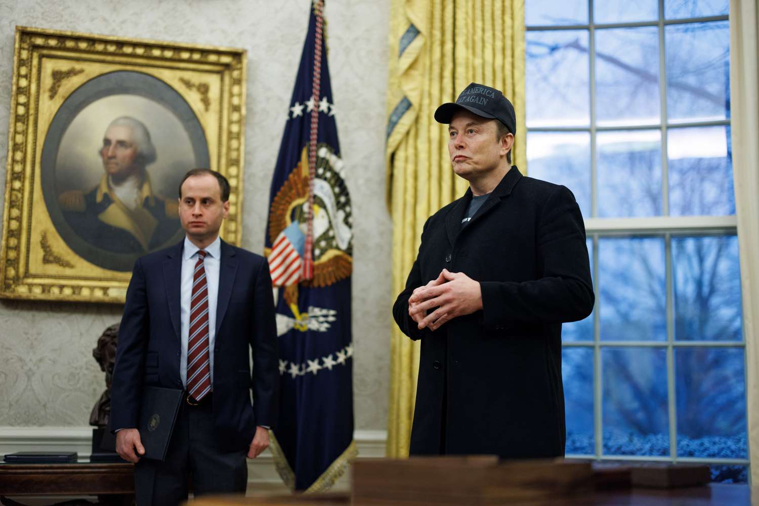 Elon Musk, chief executive officer of Tesla Inc., center, in the Oval Office of the White House.