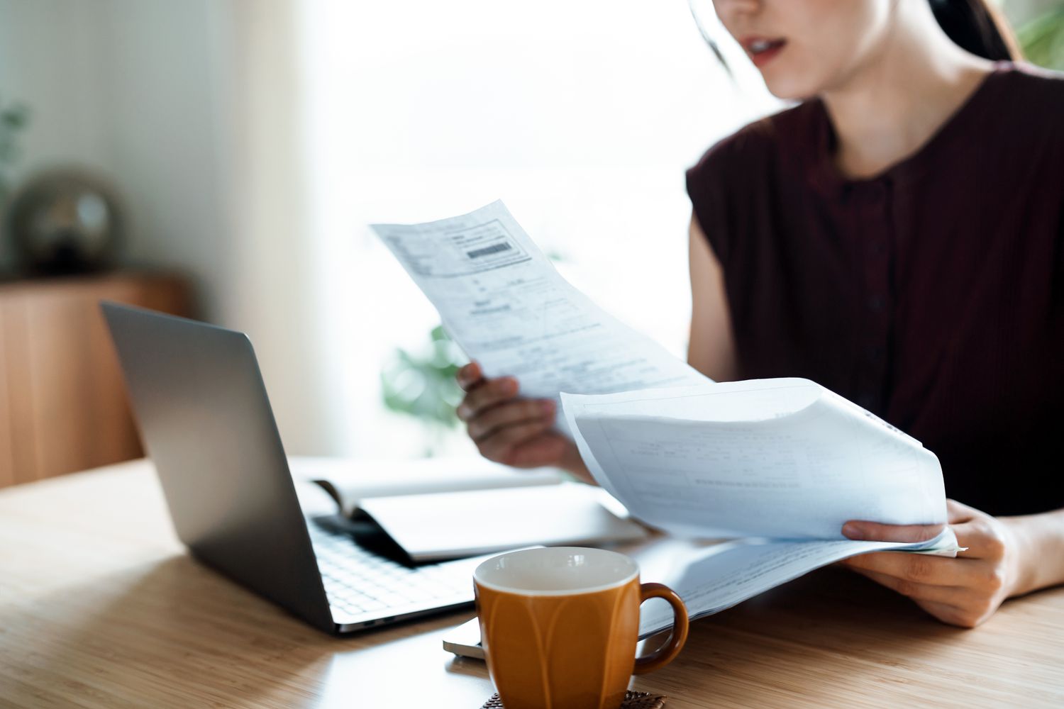 Woman looking at bills