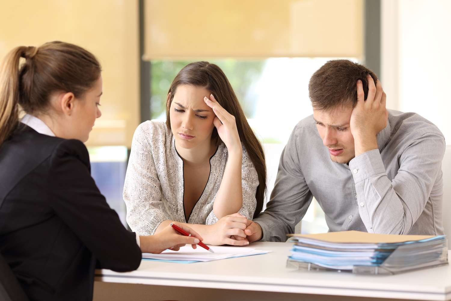 Worried customers reading a document at office.
