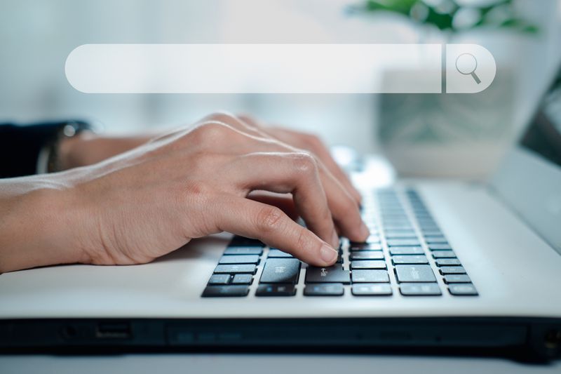 Hands on a laptop keyboard