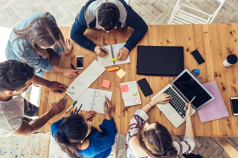 Overhead view on business people around desk