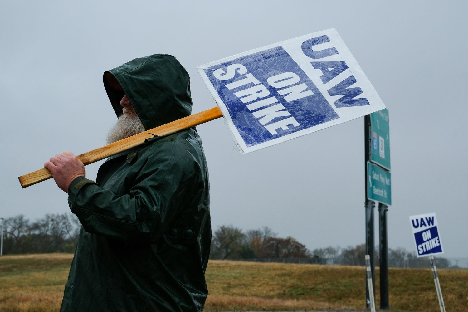 A "UAW On Strike" sign held on a picket line outside the General Motors Co. Spring Hill Manufacturing plant in Spring Hill, Tennessee, US, on Monday, Oct. 30, 2023. General Motors Co. reached a tentative agreement with the United Auto Workers, according to people familiar with the matter, bringing an end to a six-week-old strike that had upended US automobile production and cost the industry billions of dollars.