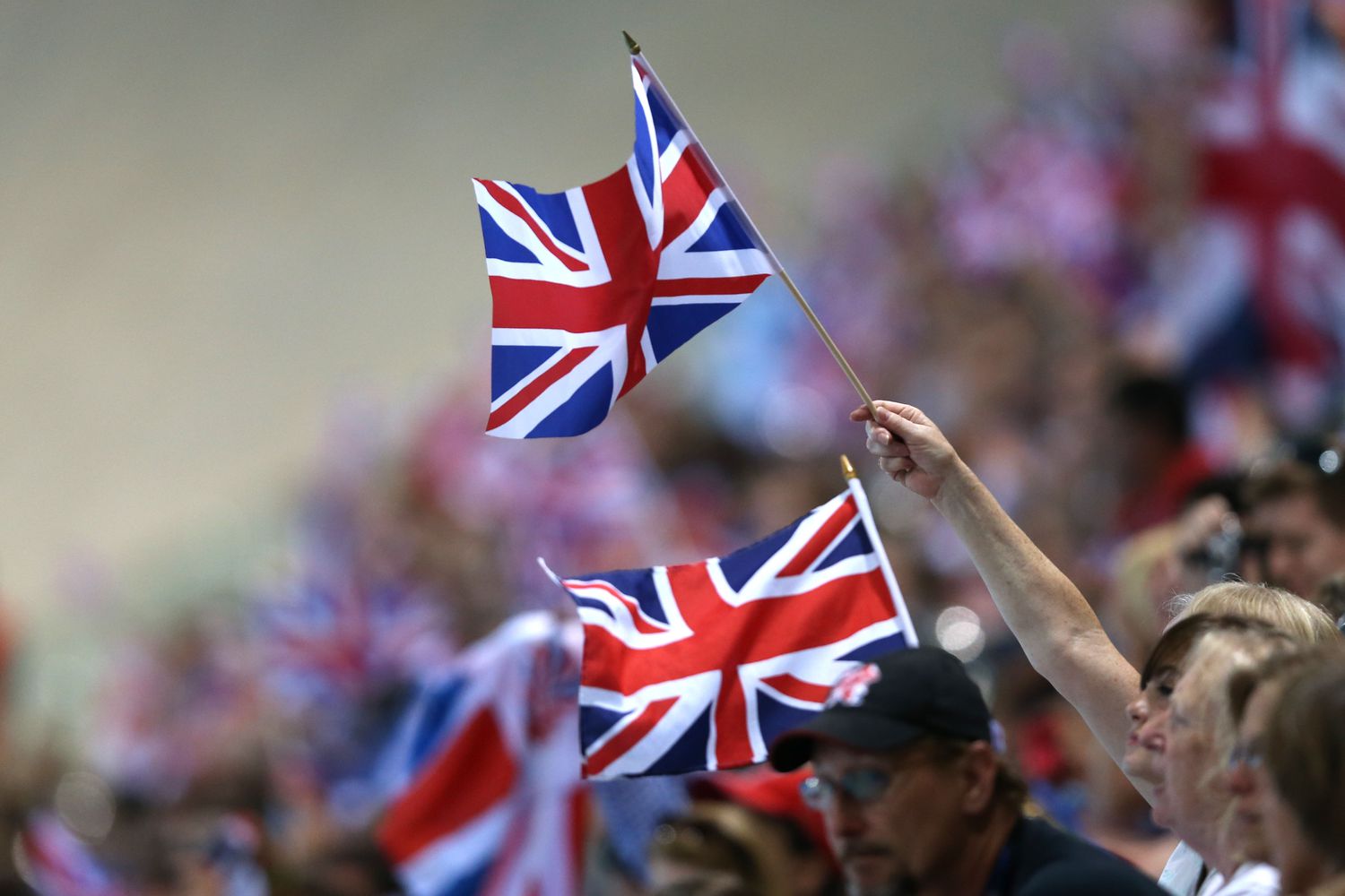 Fans wave Great Britain flags during the Men's 10m Platform Diving Preliminary