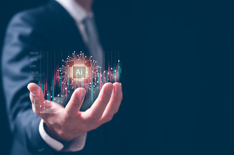 Man’s hand with image of AI in palm
