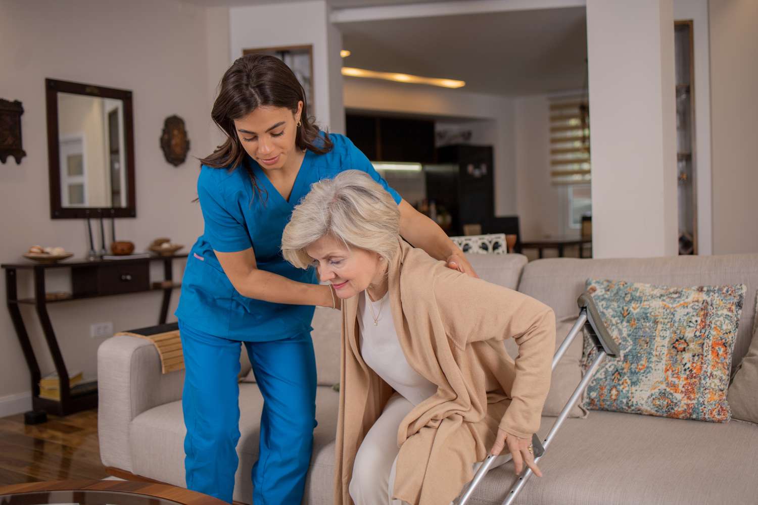 Senior getting help from nurse in her home