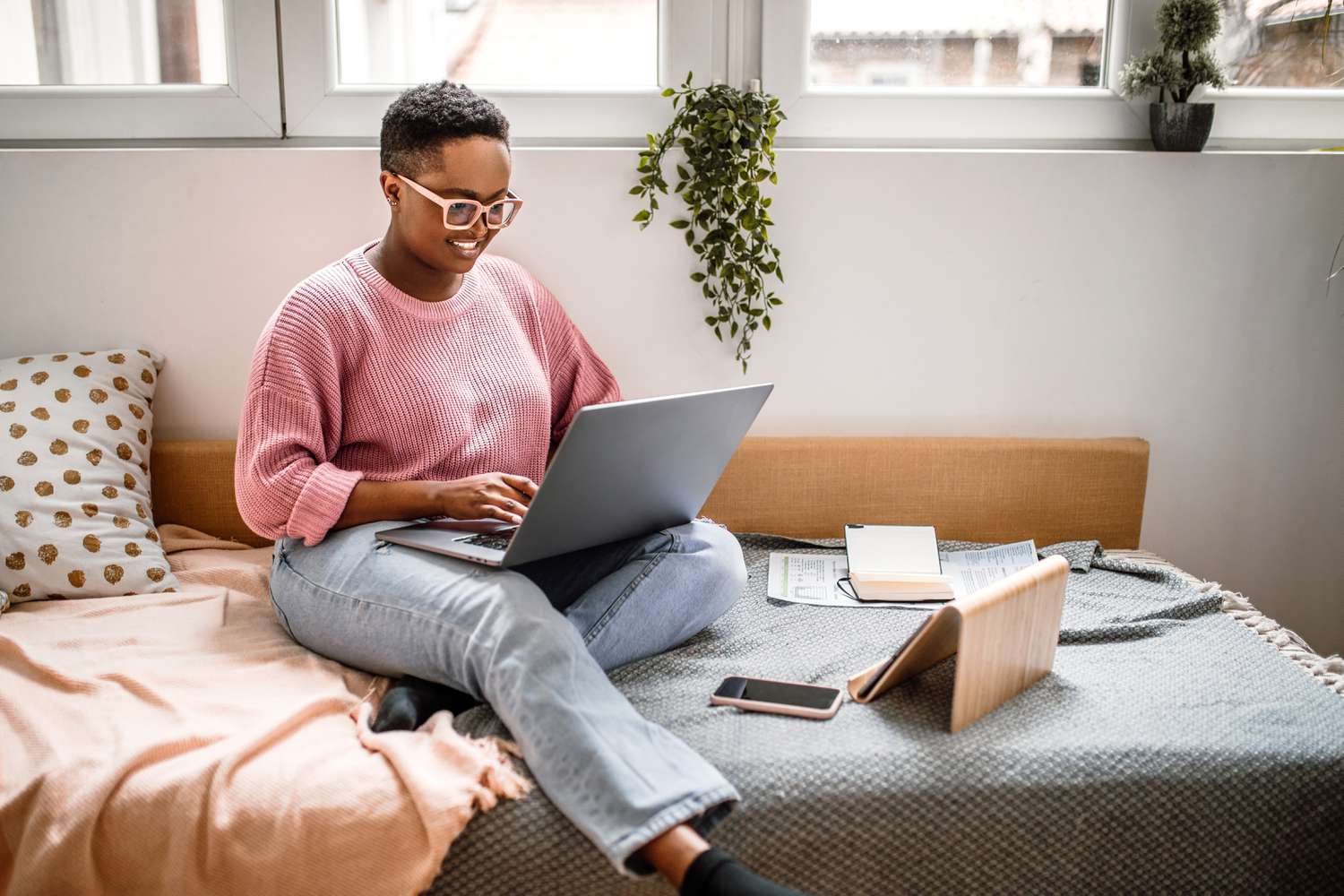 Person with glasses working on a laptop