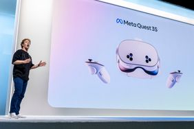 Mark Zuckerberg stands, talking in front of a large screen with the Meta Quest 3S displayed.
