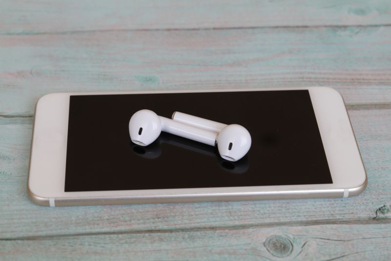 iPhone with Airpods on top
