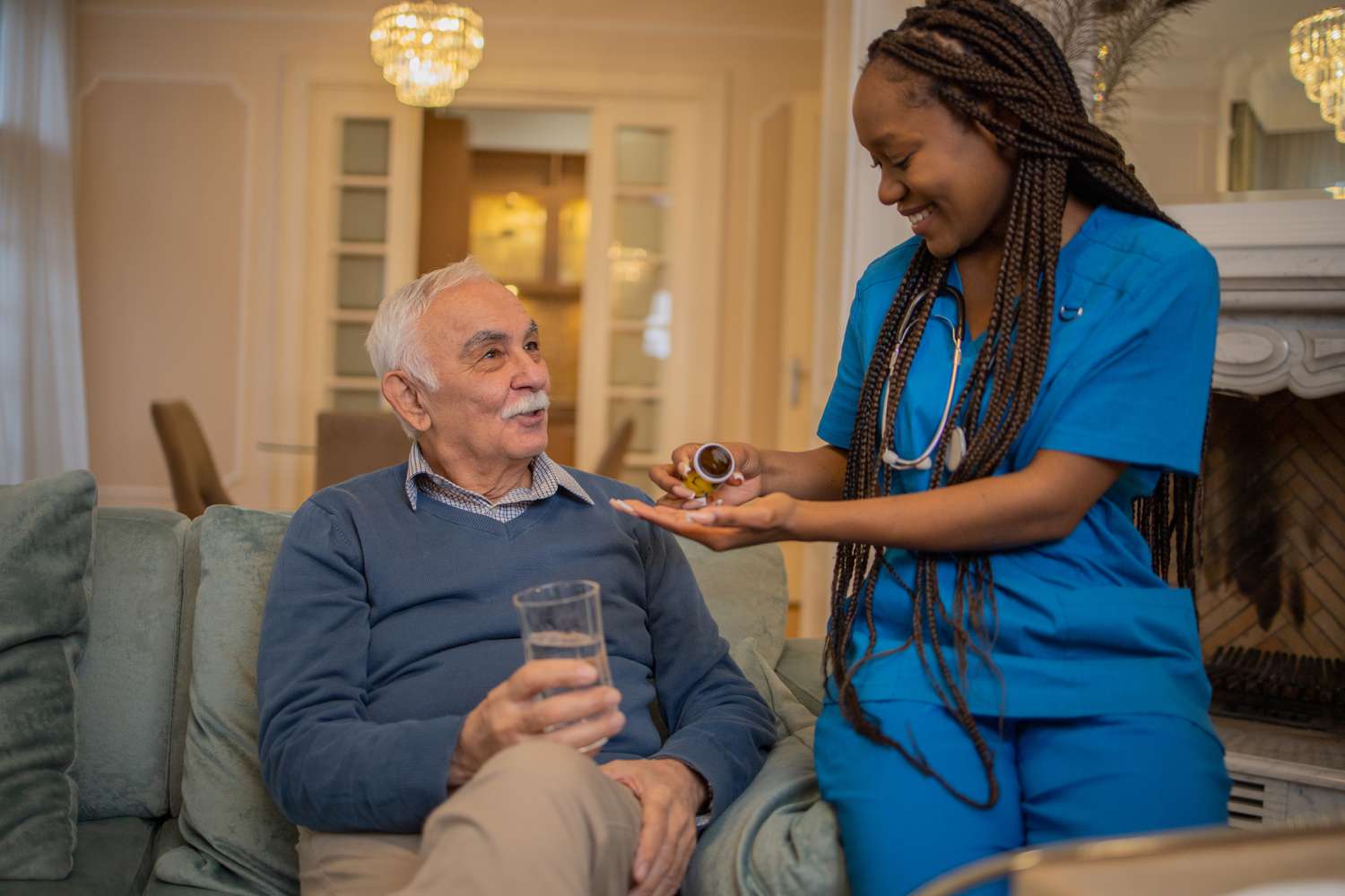 Nurse taking care of senior patient during home visit
