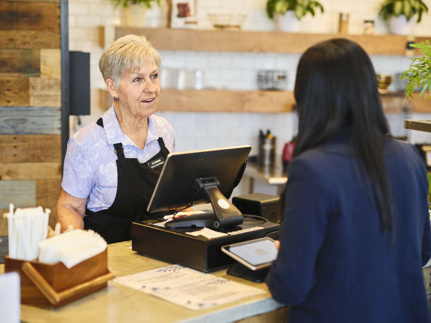 Older worker behind a cash register