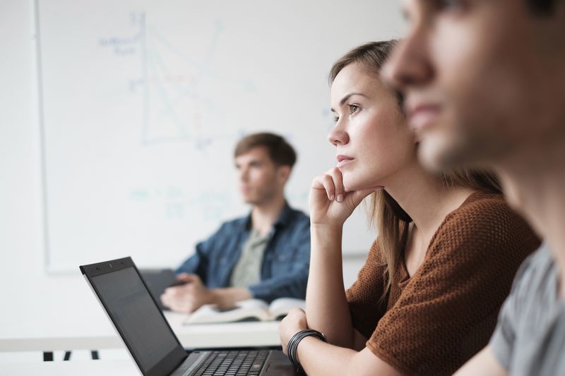 Student listening in college classroom.