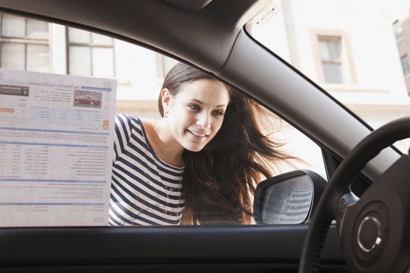 Woman Looks in Window of New Car