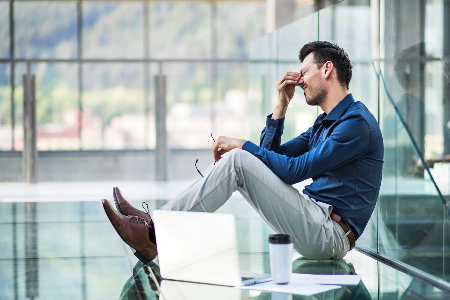 Frustrated Young Man With Laptop Sitting on the Floor