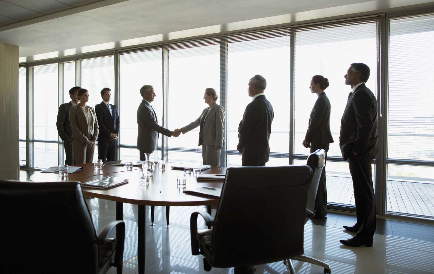 Business people shaking hands in conference room