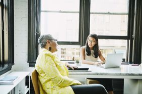 Businesswoman consulting with financial advisor in office