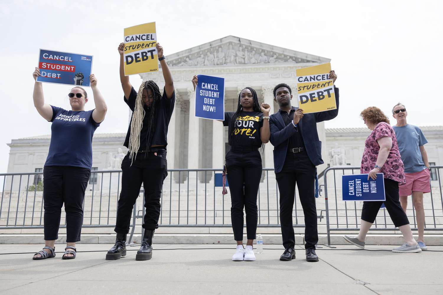 Demonstrators display signs of protest outside the U.S. Supreme Court, on Friday, June 30, 2023. The Court ruled against the Biden administration's plan for student loan forgiveness.