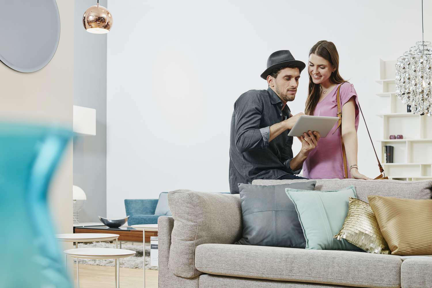 A couple uses a tablet to examine investment options. 