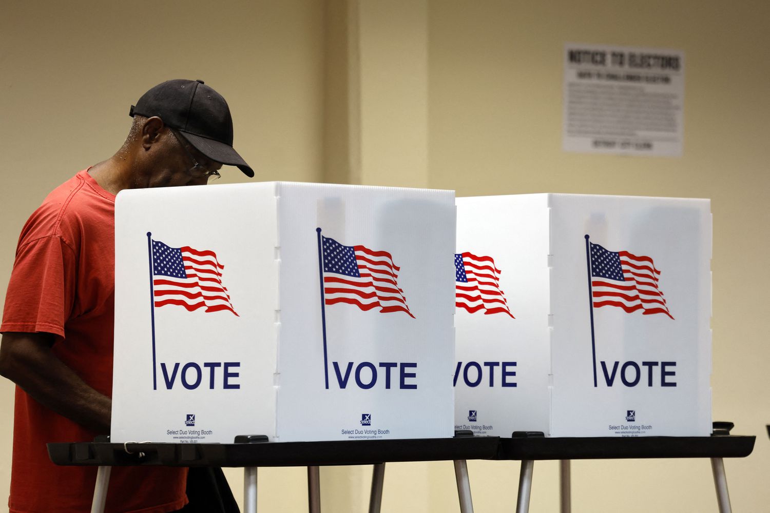 A person voting in a booth for the 2025 General Election in Detroit