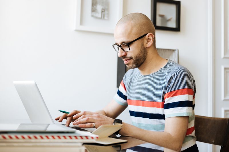 Man works on laptop at home