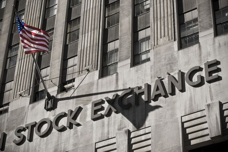 Close up view of the New York Stock Exchange building and an American flag.