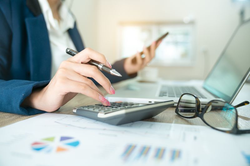 accountant or banker making calculations. Savings, finances and economy concept through a laptop.