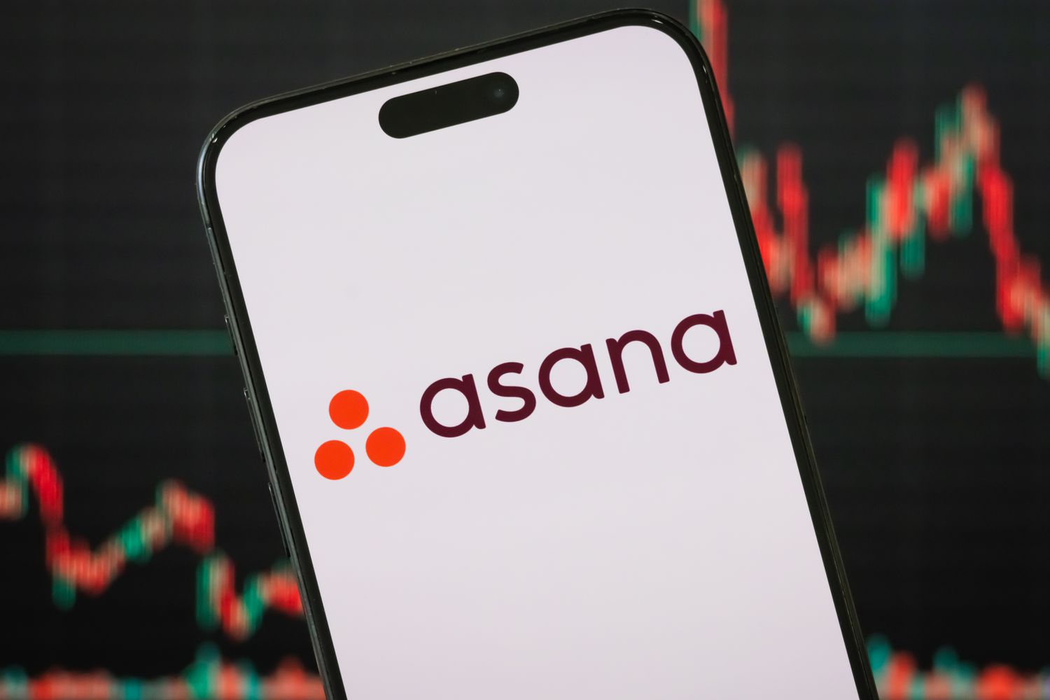 Asana logo is displayed on a smartphone screen