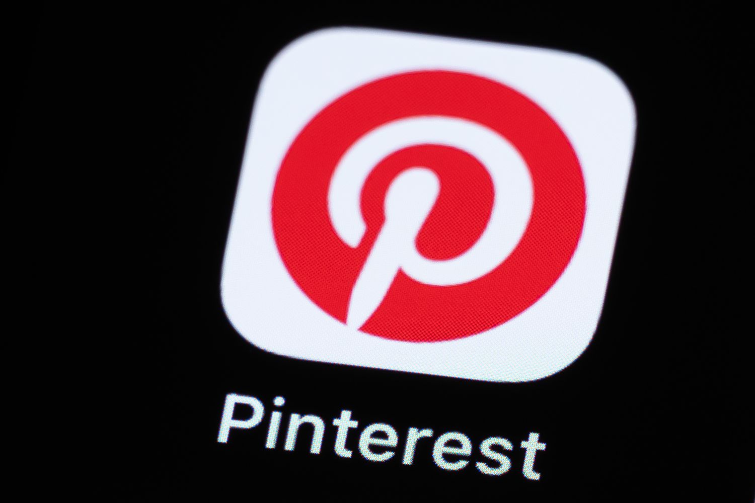 The red and white Pinterest logo is seen close up on a screen.