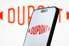 The logo of DuPont de Nemours, Inc. is displayed on a smartphone screen, with the company's red branding visible in the background