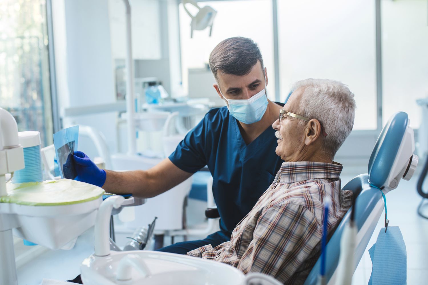 Older man at dentist looking at his x-ray