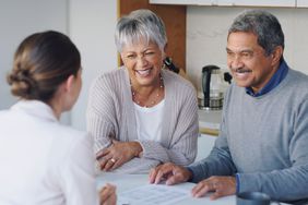 Older couple meeting with a consultant to discuss paperwork