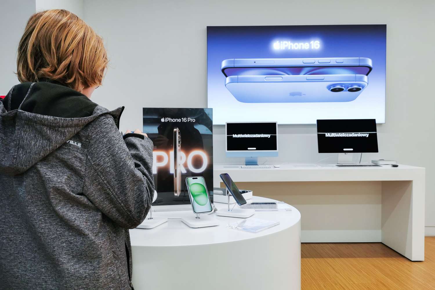 A shopper looks at merchandise in an electronics section.