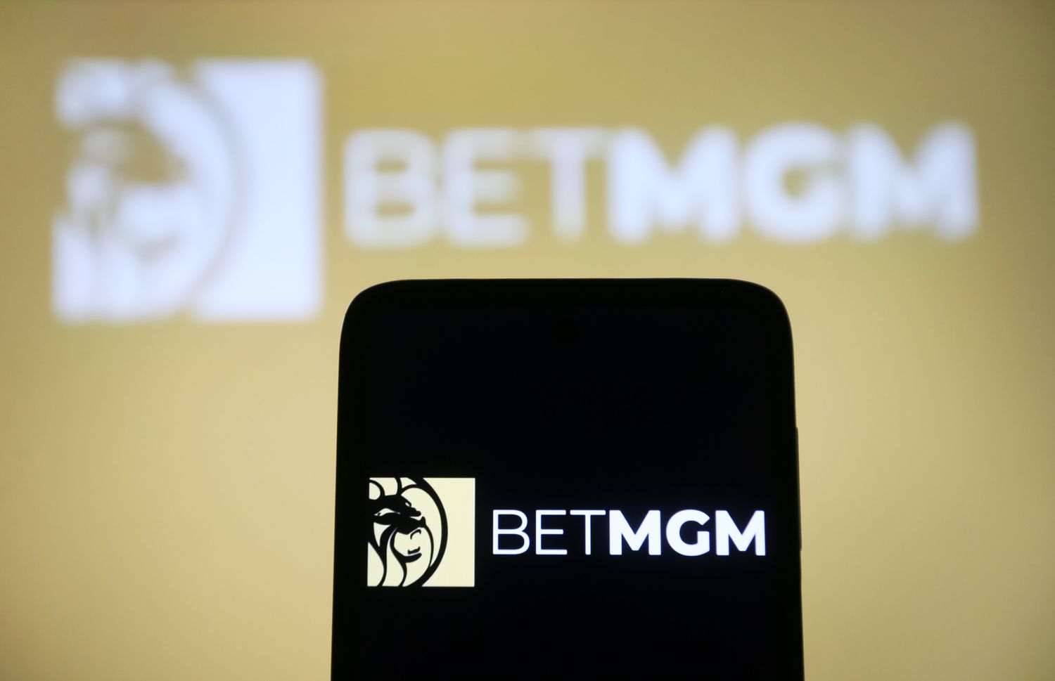 BetMGM logo is seen on a smartphone and in the background